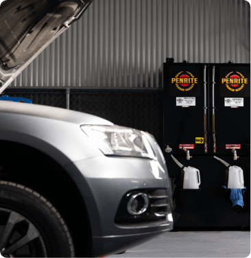 audi car in mechanic with oil tanks in background