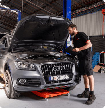 mechanic completing audi car service on audi q5