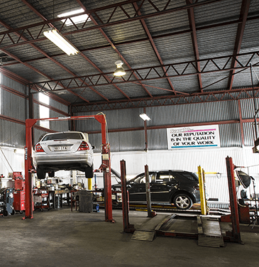 mercedes benz on car lift in mechanic workshop