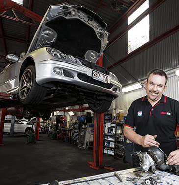 mechanic working on mercedes benz on car lift